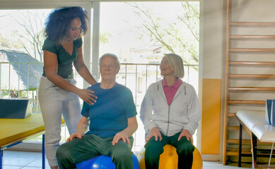 Sticker - Rehabilitation concept. Elderly couple in a gym supervised by expert african female trainer