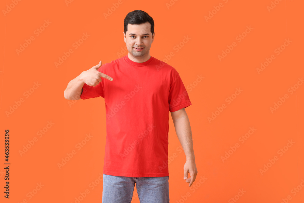 Handsome young man in stylish t-shirt on color background