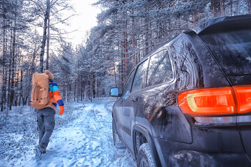 Hiking sport forest extreme winter, male traveler with a backpack next to a car in the forest view