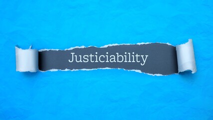 Wall Mural - Justiciability. Blue torn paper banner with text label. Word in gray hole.