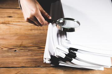 Wall Mural - woman holding magnifying glass and documents