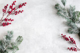Fototapeta Mapy - Christmas composition. Fir tree branches, red berries on gray background. Christmas, winter, new year concept. Flat lay, top view, copy space