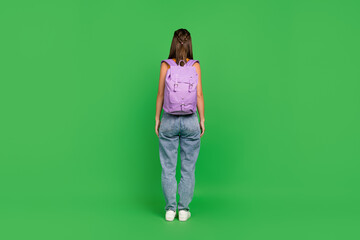 Poster - Full length back photo of young brunette lady wear bag top jeans shoes isolated on green color background