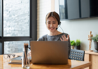 Cropped shot smiling asian woman freelancer wearing headset, communicating with client via video computer call. Millennial pleasant professional female tutor giving online language class