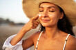 Woman using sunscreen cream. Beautiful girl with sun protection cream