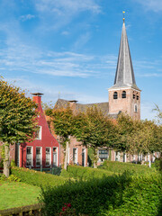 Wall Mural - Mauritiuskerk and waterside gardens on Eegracht canal in IJlst, Friesland, Netherlands