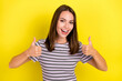 Photo of funky young brunette lady show thumb up wear striped t-shirt isolated on yellow background