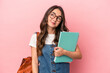 © Asier - Young caucasian student woman isolated on pink background dreaming of achieving goals and purposes