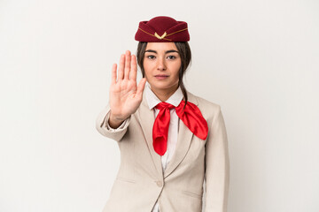 Young caucasian stewardess woman isolated on white background standing with outstretched hand showing stop sign, preventing you.