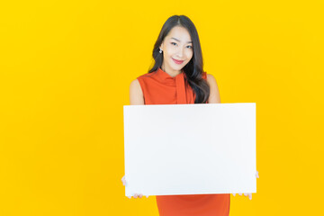 Wall Mural - Portrait beautiful young asian woman with empty white billboard