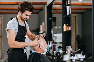 Senior good looking gettingt haircut in a hairdresser's salon.