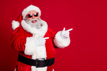 Wall Mural - Photo of promoter pensioner funny man direct finger empty space wear santa hat costume isolated red color background