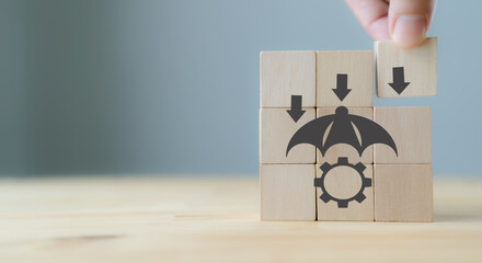 Risk Management Concept. Business Strategy and Development. Businessman put the wood cube with risk management symbols on grey background with copy space. Business adaptation. Digital disruption.