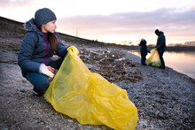 Preteen Girl Cleaning Polluted Sea Shore From Plastic Garbage With Her Family