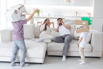 Wall Mural - Happy family playing dinosaurs at home