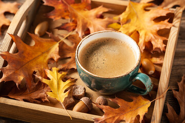 Wall Mural - Autumn background with cup of black coffee and fall decoration