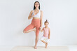 © Вадим Каштанов - Young attractive mother meditates with her little daughter. Balance exercise. Couple yoga.