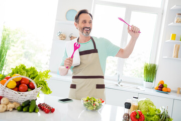 Sticker - Photo of cheerful carefree age man dressed blue t-shirt apron smiling cooking salad dancing indoors home room