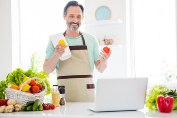 Sticker - Photo of good mood cheerful age man dressed blue t-shirt apron smiling cooking watching modern gadget indoors home room