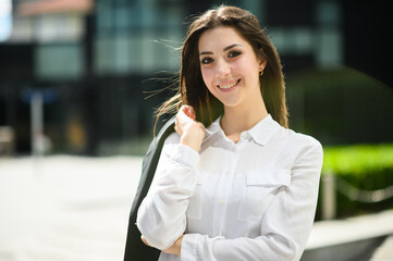 Wall Mural - Confident young female manager outdoor in a modern urban setting