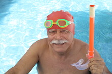 Senior Man With A Mustache Having A Blast In The Pool