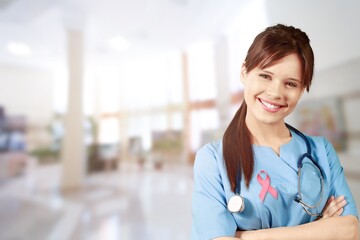 Wall Mural - Beautiful doctor with beautiful toothy smile showing a Pink satin Ribbon