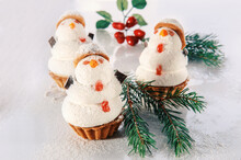 Three Snowmen Made Of Sweet Meringue With Christmas Decorations. Original Cookies With Marshmallows And Meringue On The Christmas Table. Cookies In The Form Of A Snowman