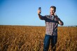 © Serhii - Farmer taking pictures of soybean plantation. Quality control. Agronomist's work. Brazilian Farm.