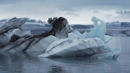 Wall Mural - Icebergs floating. Ices and icebergs. Glacier lagoon. Greenland iceberg. Melting ice. South coast Iceland. Jokullsarlon glacier lagoon. Volcanic ash on the ice. Ice age glacier. Melting iceberg. 