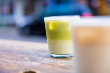 Canvas Print - Selective-focus shot of a glass of f resh matcha tea and latte