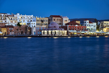 Wall Mural - Historic mosque and houses in the evening in the port of Chania city