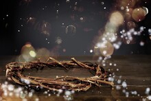 Crown Of Thorns On Wooden Cross With Sparkling In Background