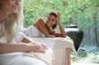 © Jovo Jovanovic/Stocksy - Woman Lying on Her Side Smiling at Her Friend