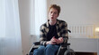 © iaginzburg - A young man is sitting in a wheelchair and talking to the camera