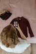 © Sergey Narevskih/Stocksy - Woman taking photo of clothes for ad on internet