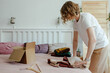 © Sergey Narevskih/Stocksy - Woman packing wear for selling on internet