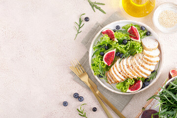 Canvas Print - Chicken breast baked and fresh salad of lettuce, arugula, blueberry and figs. Healthy diet food. Top view.