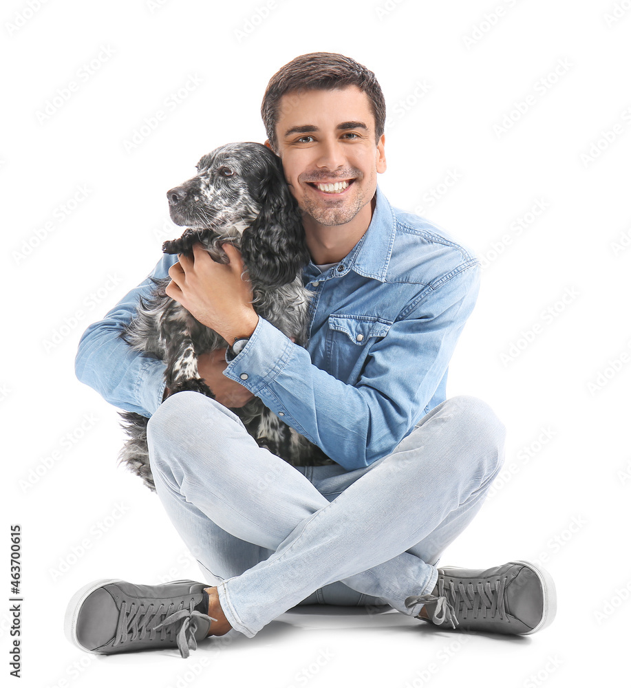 Happy young man with cute dog on white background