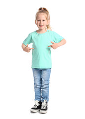 Poster - Little girl with ponytail pointing at blue t-shirt on white background