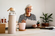 © Eloisa Ramos/Stocksy - Mature woman working at office