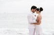 © Ezequiel Giménez/Stocksy - Tender newlyweds hugging on beach