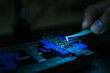 © Manu Padilla/Stocksy - Engineer inserting microchip into micro scheme