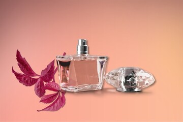 Perfume Bottle with autumn leaf on desk background. Beauty concept