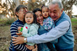 © Erin Brant/Stocksy - Joyful extended family hug