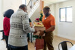 © Jayme Burrows/Stocksy - Young Man Hands Over Presents to Older Man
