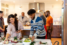Family Prepares A Holiday Dinner Together