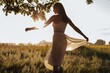 © Liliya Rodnikova/Stocksy - Woman swirling in sunset