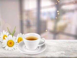 Poster - Chamomile tea in a mug with natural small chamomile flowers