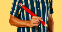Man About To Write With A Large Red Pencil