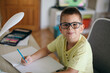 © Mosuno/Stocksy - Boy Doing Homework in his Room
